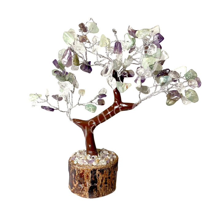 A wire gemstone bonsai tree with amethyst, crystal quartz and green aventurine chips, mounted on a natural base.