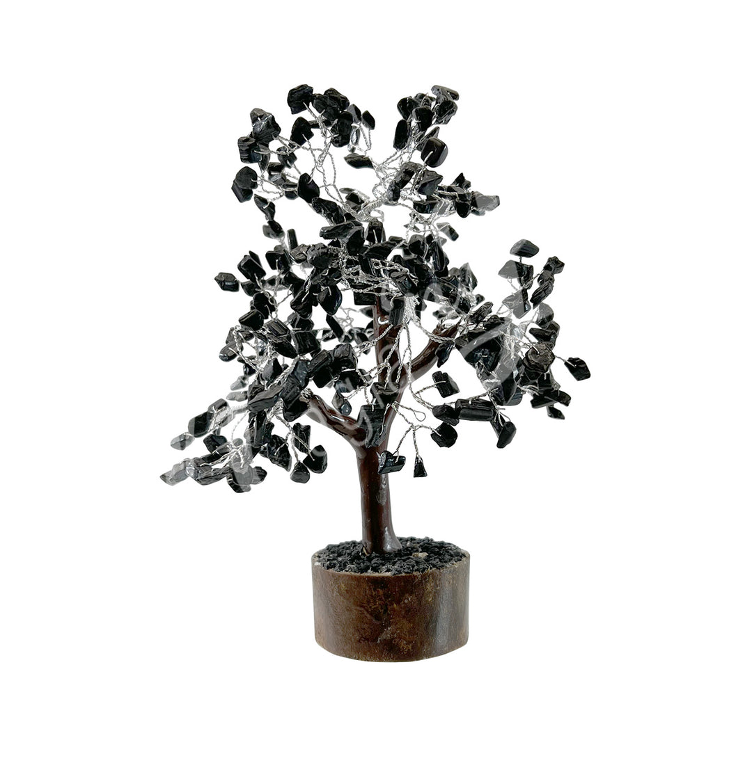 A wire gemstone bonsai tree with black tourmaline crystal chips, mounted on a natural base.