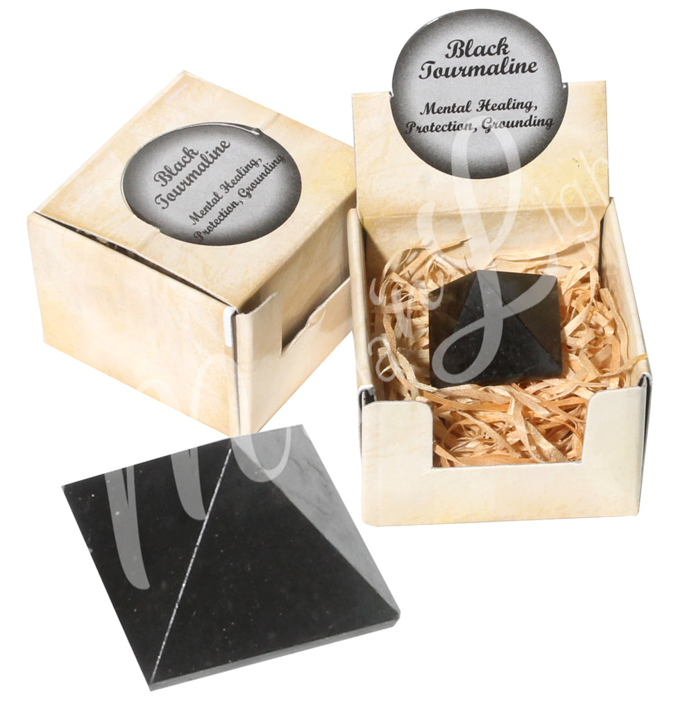A closed gift box with the words "Black Tourmaline, Mental Healing, Protection, Grounding" on it;
an open gift box showing a stone with the same inscription on top, and the Black Tourmaline pyramid at the bottom.