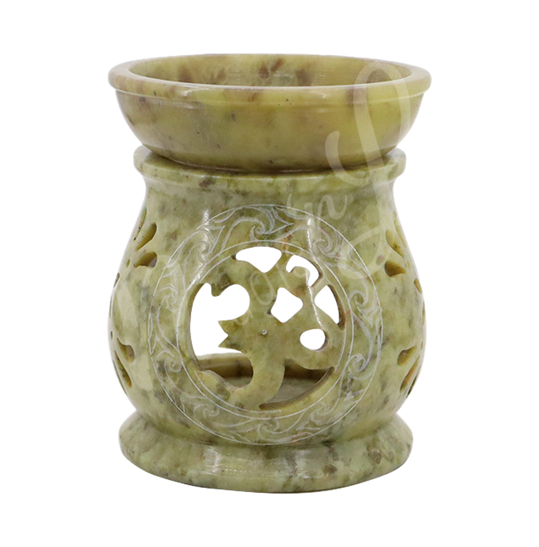 Greenish soapstone oil burner with a carved OM cut out design and round bowl on top, designed to hold oil or wax, with space for a tealight candle inside.