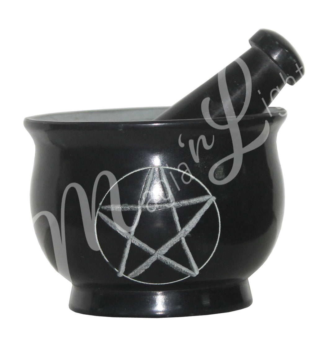 Black soapstone mortar featuring a pentacle design on the front and pestle set.
