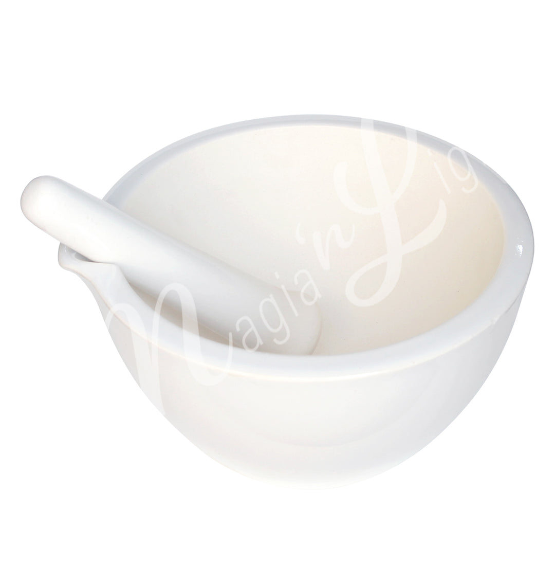 White ceramic mortar and pestle set with a cutout for the pestle.