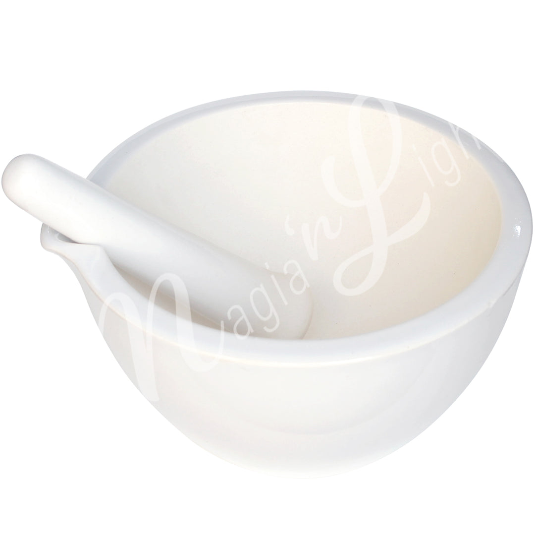 White ceramic mortar and pestle set with a cutout for the pestle.