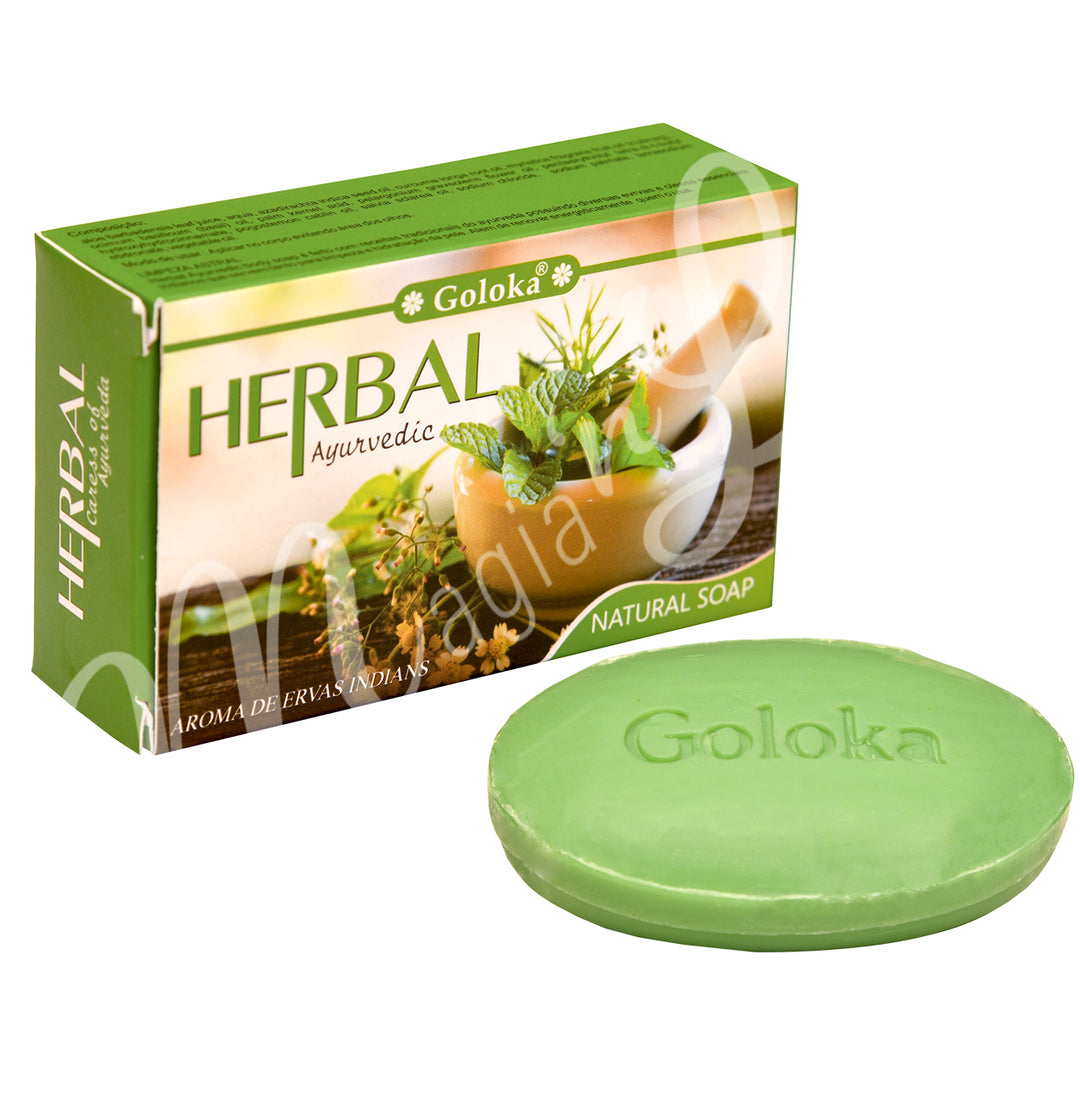 A photo of the retail box with the soap outside.The words on the packaging : goloka, herbal, ayurvedic, aroma de ervas indians and natural soap are on the front.