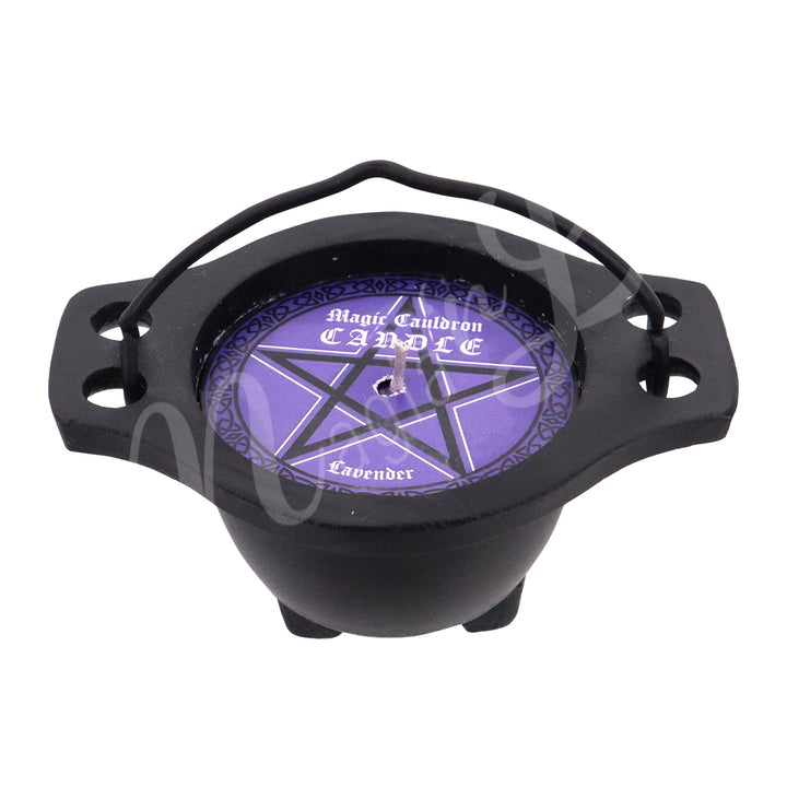 Small black cauldron-shaped candle holder with a handle, containing a purple candle. The label on top reads “Magic Cauldron Candle – Lavender” and features a black pentagram on a purple background.
