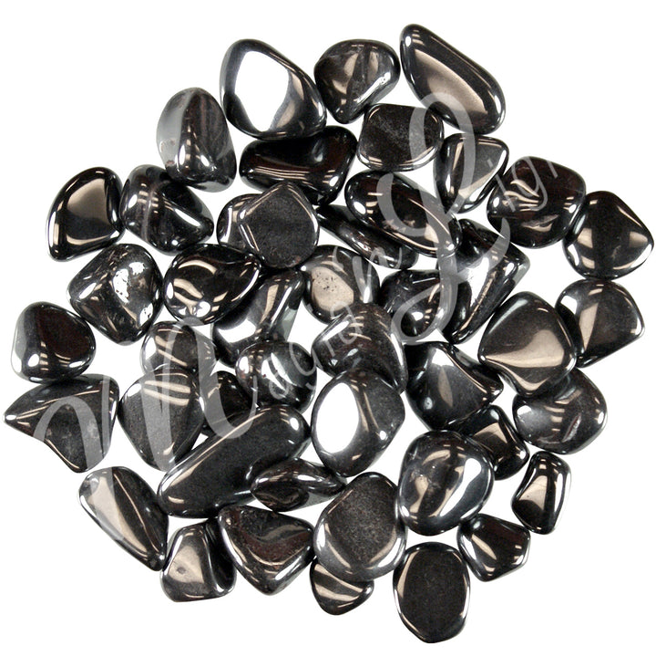 Collection of polished tumbled stones in shades of black, arranged together in a circular pile.