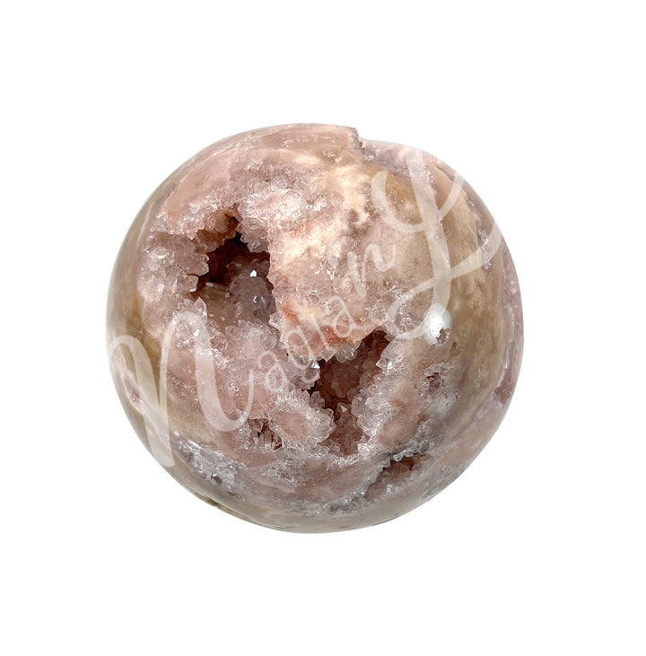 A sphere made of pink amethyst, with a sparkling druzy crystal center