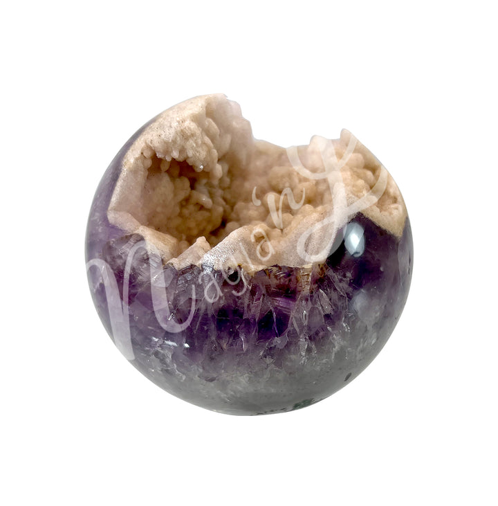 A open sphere made of pink amethyst, with a sparkling druzy crystal center.