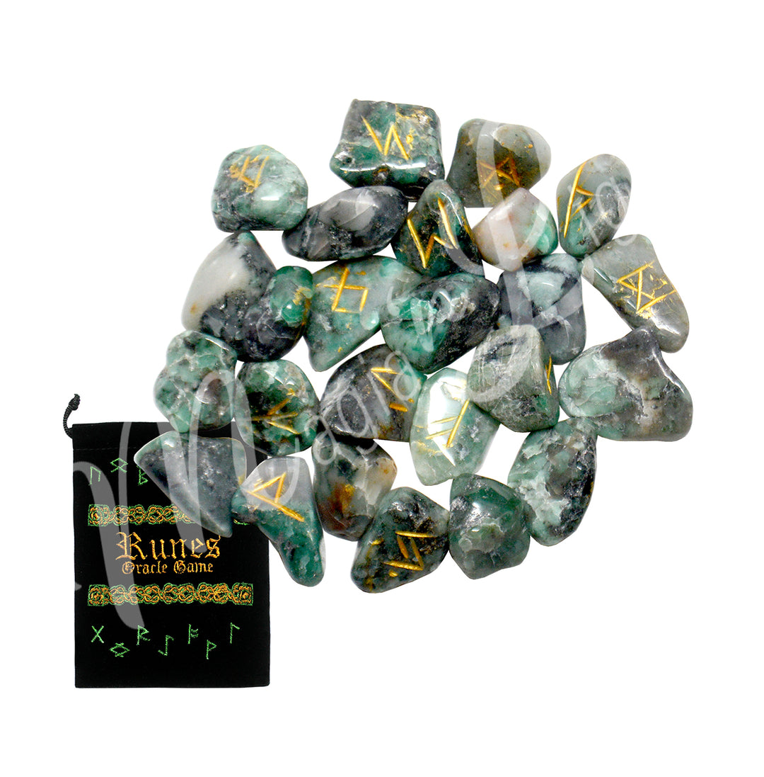 A set of emerald runestones with engraved and painted gold symbols, displayed with a black velvet pouch. The pouch is embroidered with the words "runes oracle game", as well as runic symbols.
