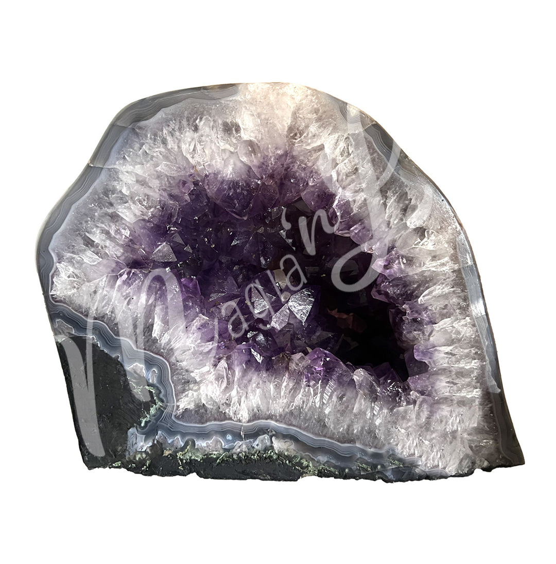 Front view of an amethyst cathedral. The center is purple with glitter while the sides go from white to gray on the exterior.