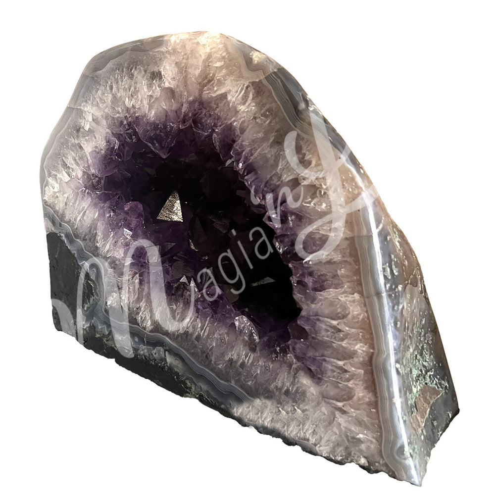 Side view of an amethyst cathedral. The center is purple with glitter while the sides go from white to gray on the exterior.