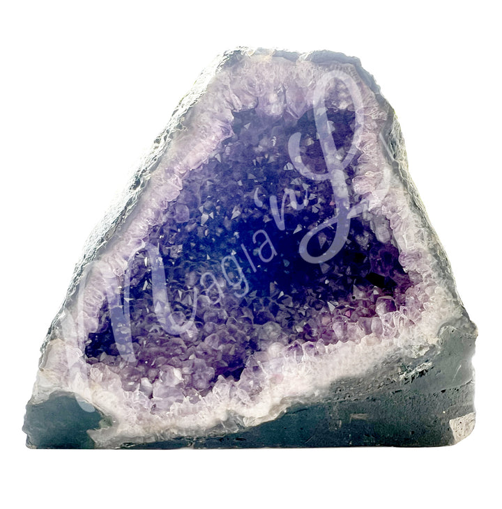 Front view of an amethyst cathedral. The center is purple with glitter while the sides go from white to gray on the exterior.