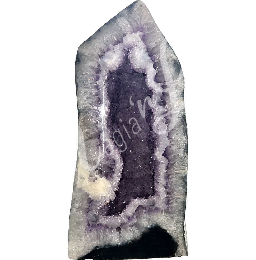 Front view of a long amethyst cathedral. The center is purple with glitter while the sides go from white to black on the exterior.