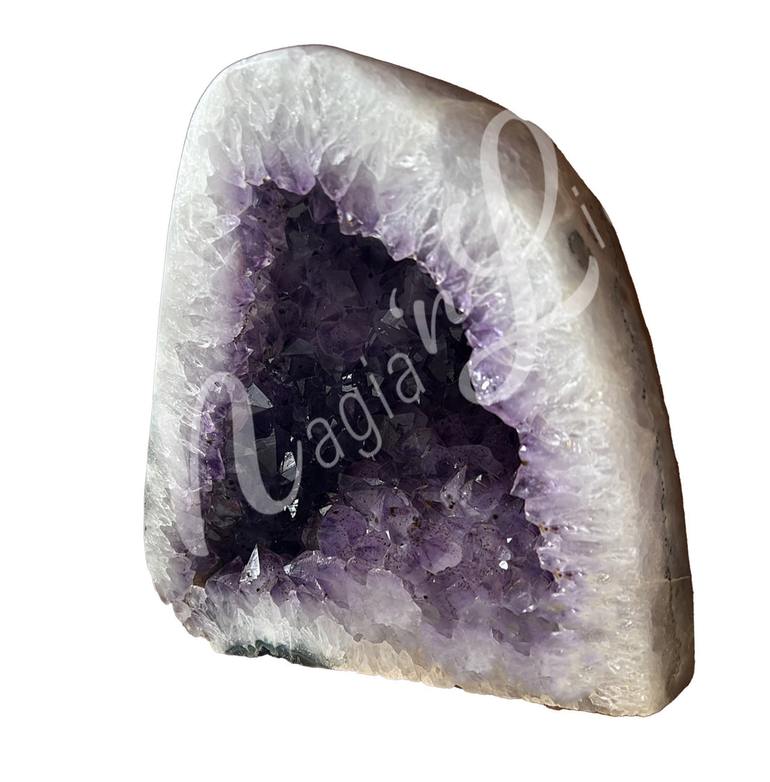 Side view of an amethyst cathedral. The center is purple with glitter while the sides go from white to black on the exterior.