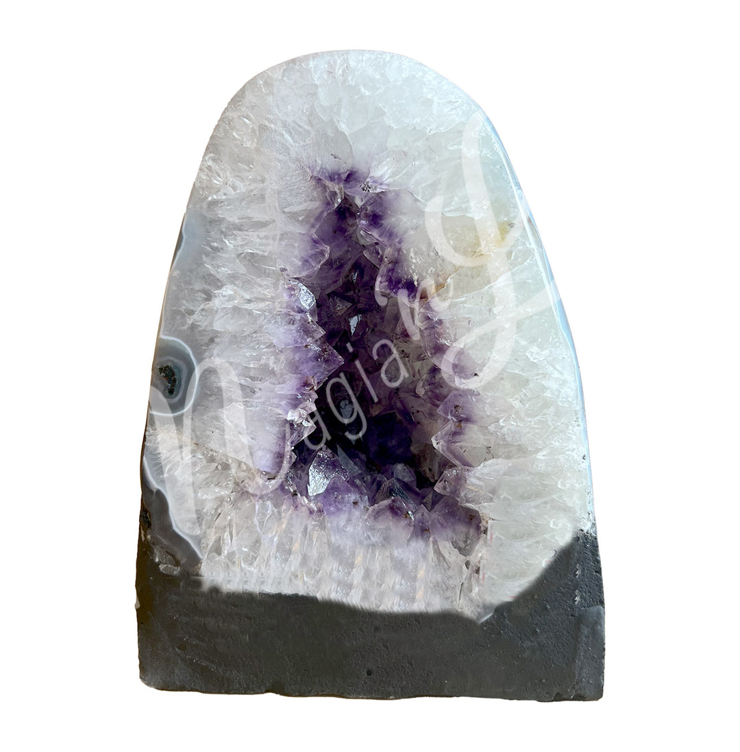 Front view of an amethyst cathedral. The center is purple with glitter while the sides go from white to gray on the exterior.