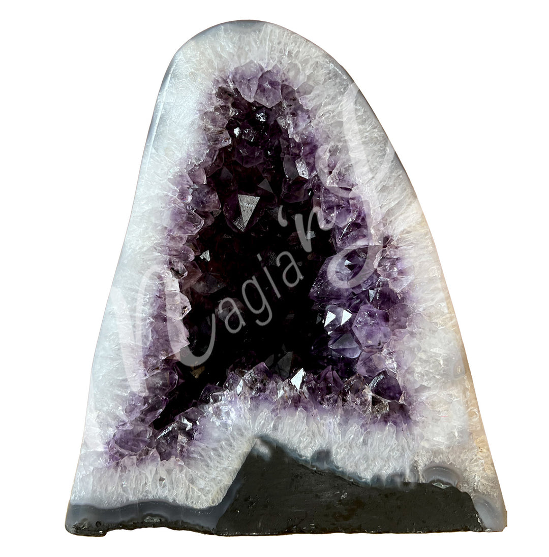 Front view of an amethyst cathedral. The center is purple with glitter while the sides go from white to beige on the exterior.