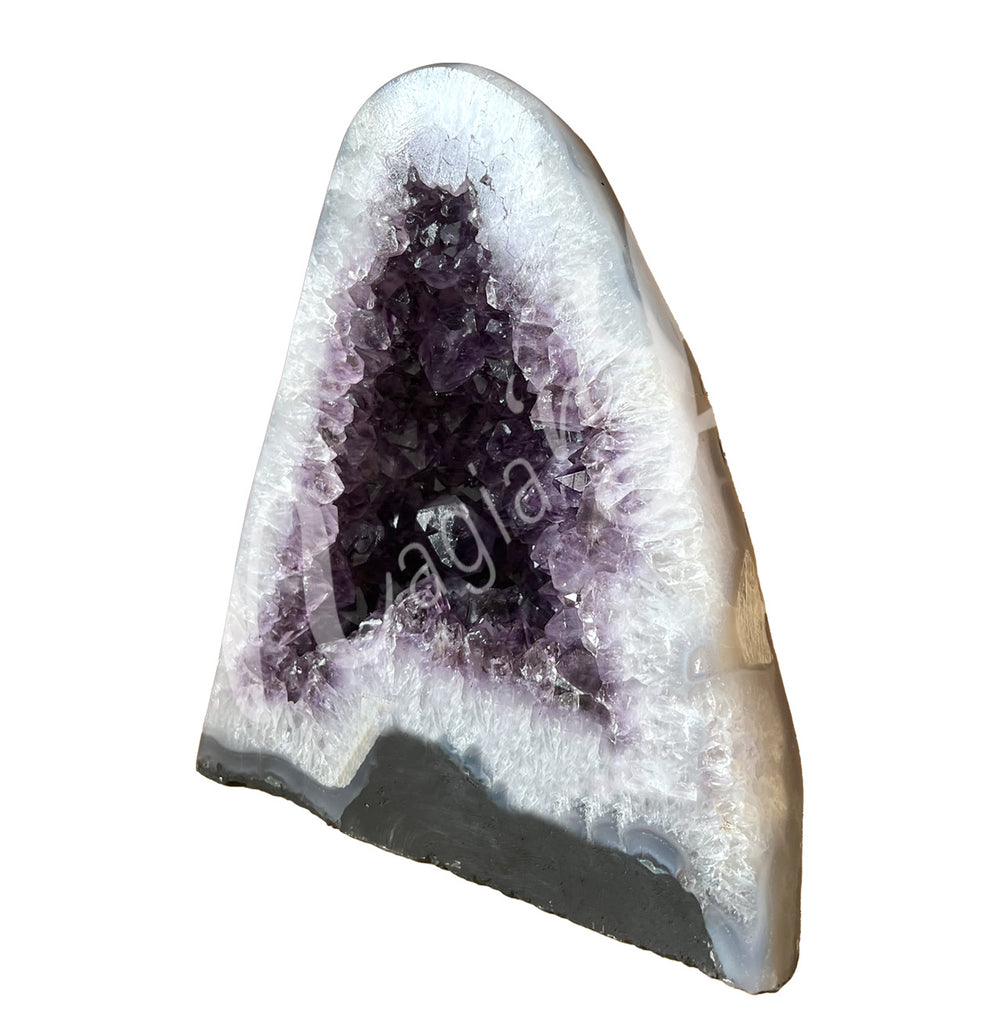 Side view of an amethyst cathedral. The center is purple with glitter while the sides go from white to beige on the exterior.