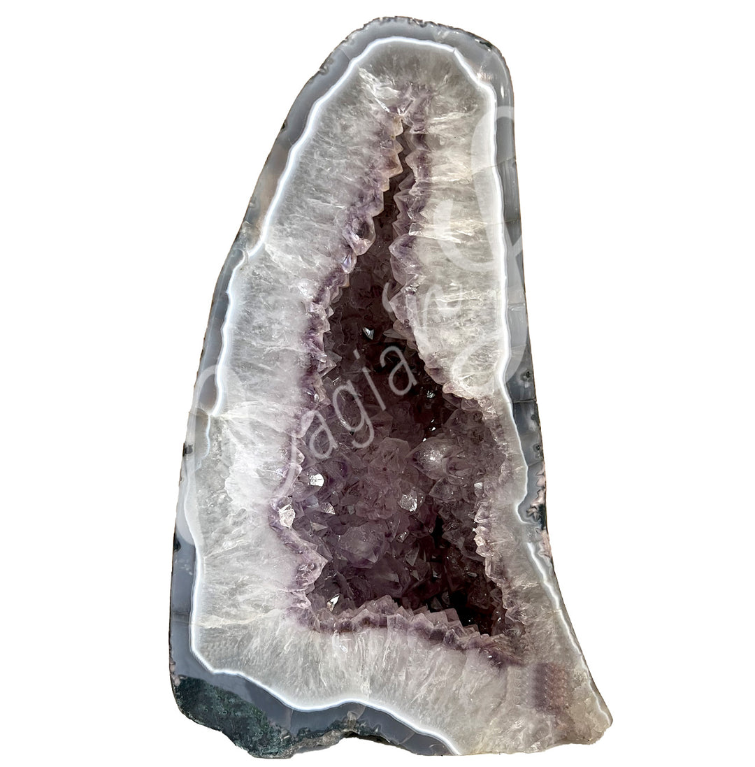 Front view of a long amethyst cathedral. The center is purple with glitter while the sides go from white to black on the exterior.