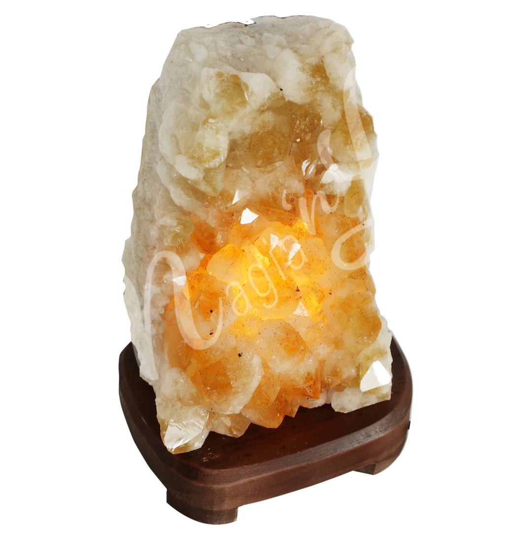 A druse citrine lamp mounted on a brown wooden base