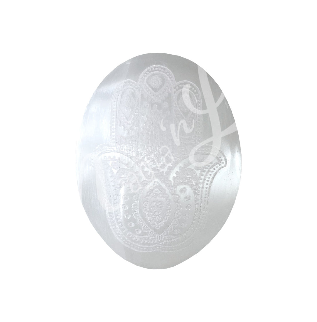 Polished Selenite palm stone engraved with a Hand of Fatima design.