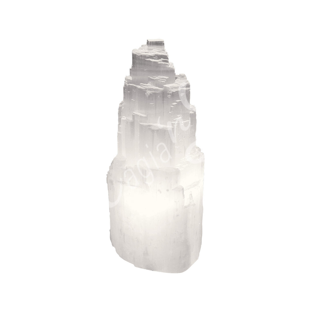 Selenite iceberg carving with black rubber feet.