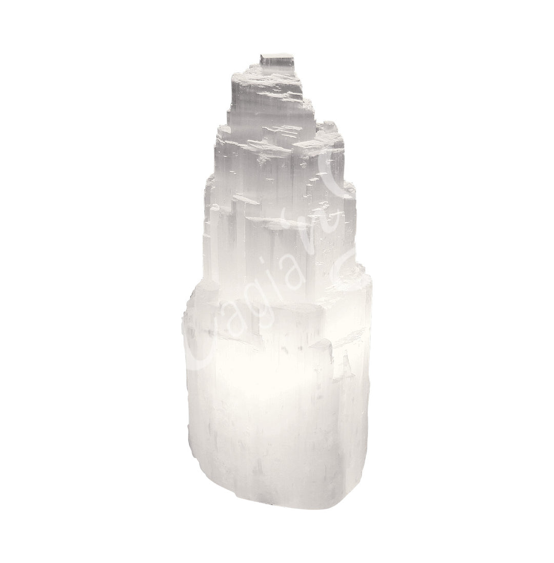 Selenite iceberg carving with black rubber feet.