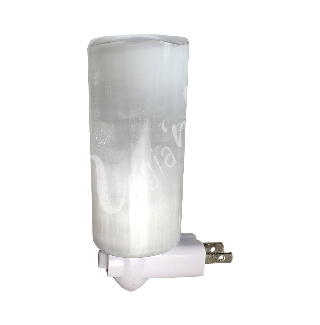 A cylinder selenite attached to a small light fixture.