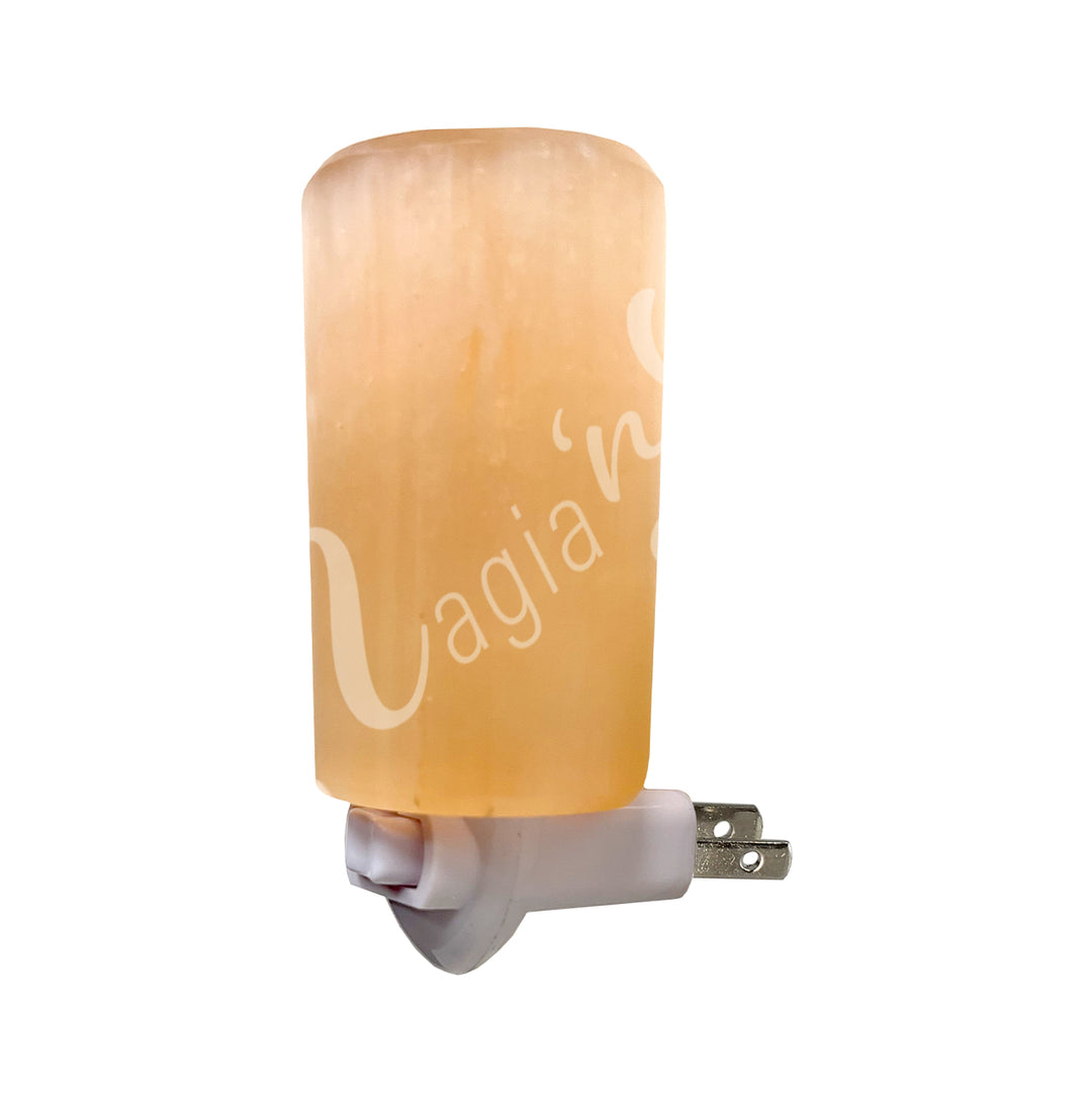 An orange cylinder selenite attached to a small light fixture.