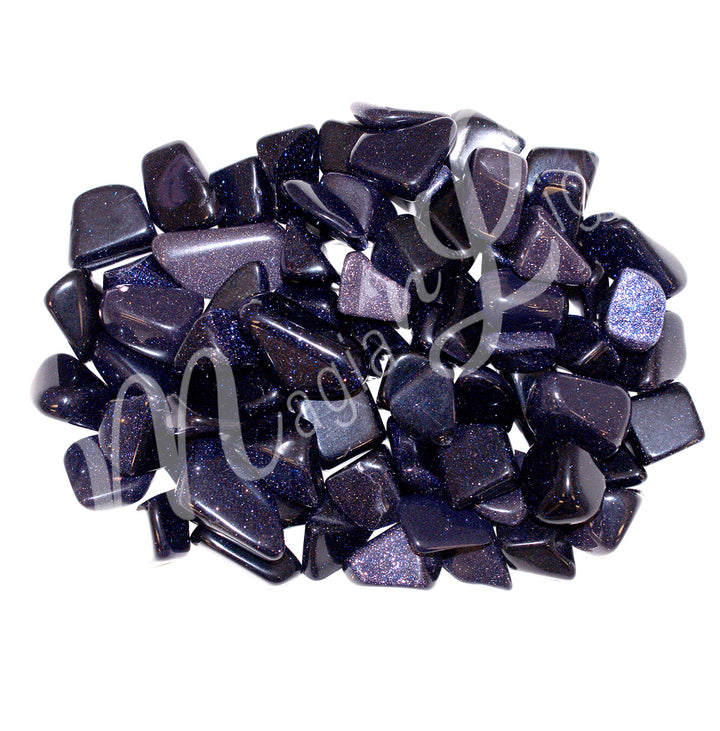 Collection of polished tumbled stones in shades of purple, blue, and black, arranged together in a circular pile.