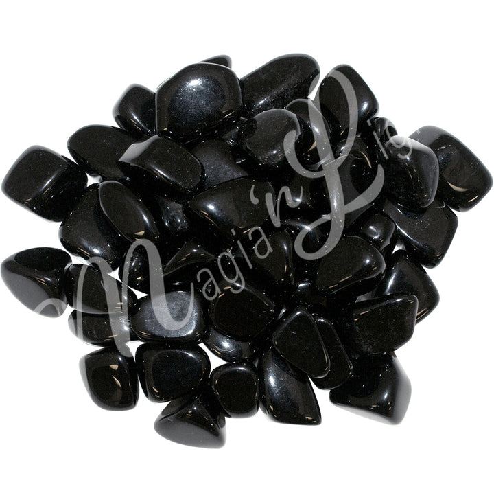 Collection of black polished tumbled stones arranged together in a circular pile.
