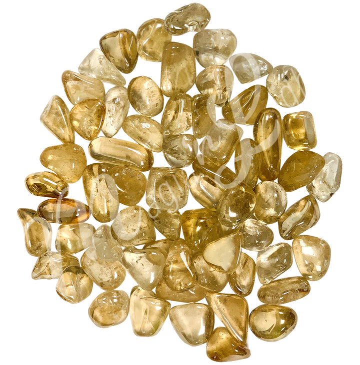 Collection of polished tumbled stones in shades of yellow, arranged together in a circular pile.