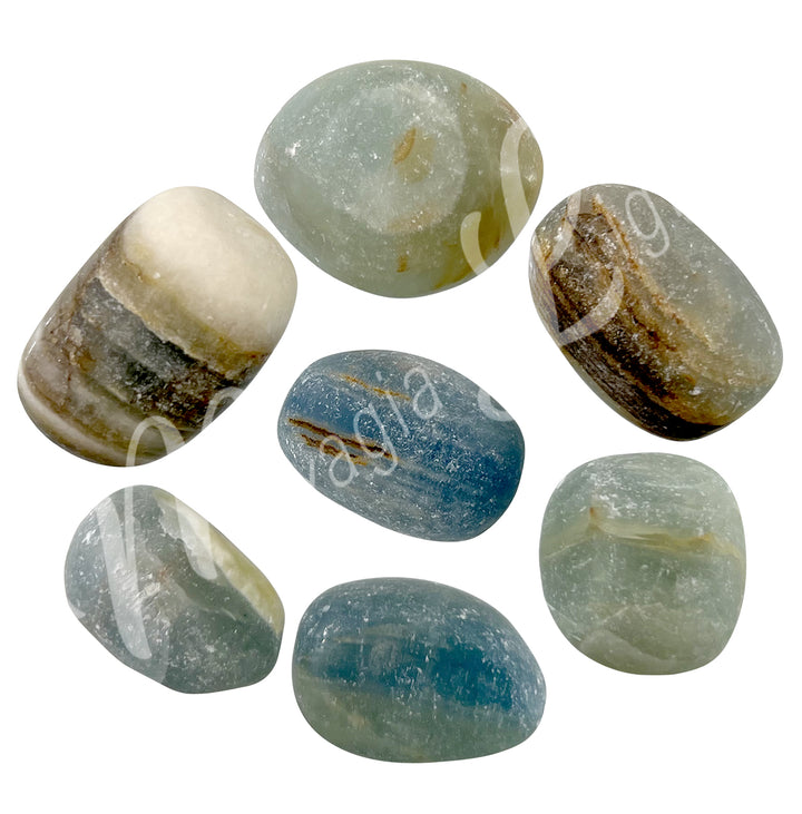 Seven tumbled sotnes of matte blue onyx arranged in a circular pattern.