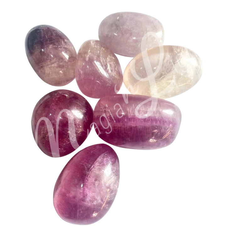 Collection of polished tumbled stones in shades of pink and white with transparency, arranged together in a pile.