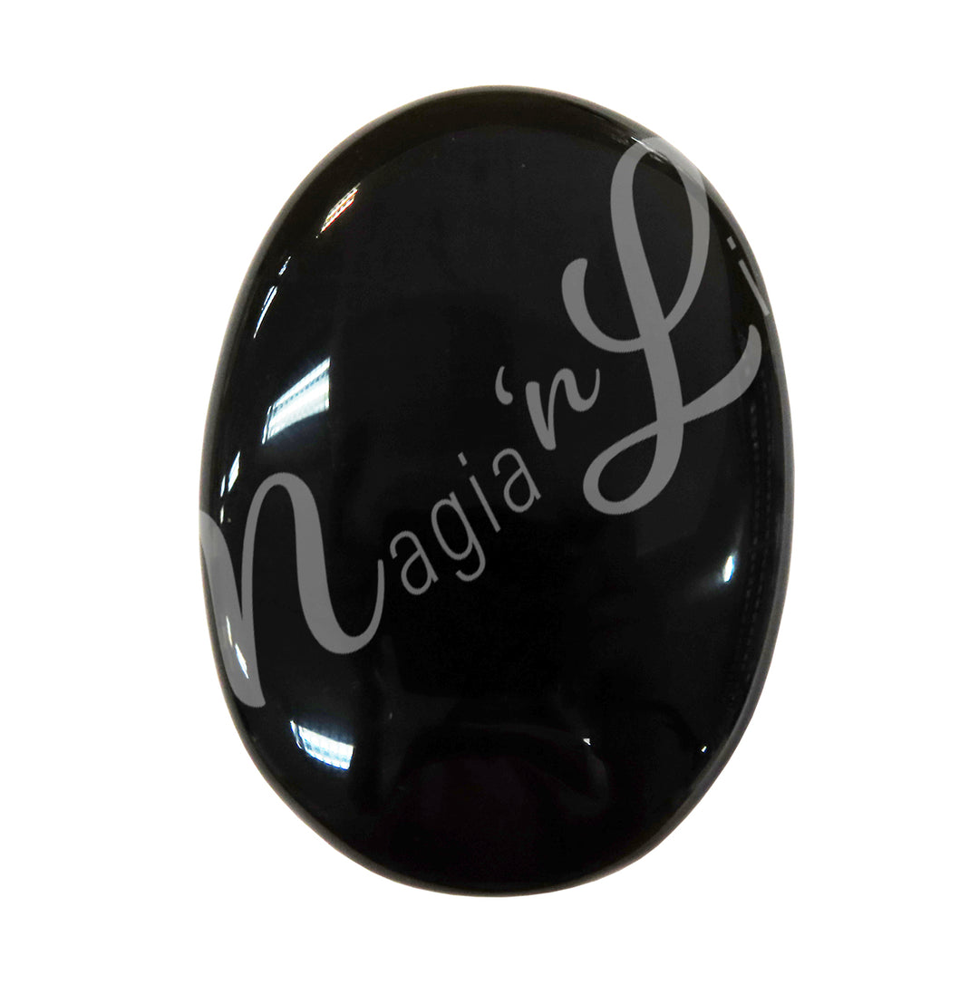 Close-up of a polished oval palm stone made of Black Obsidian.