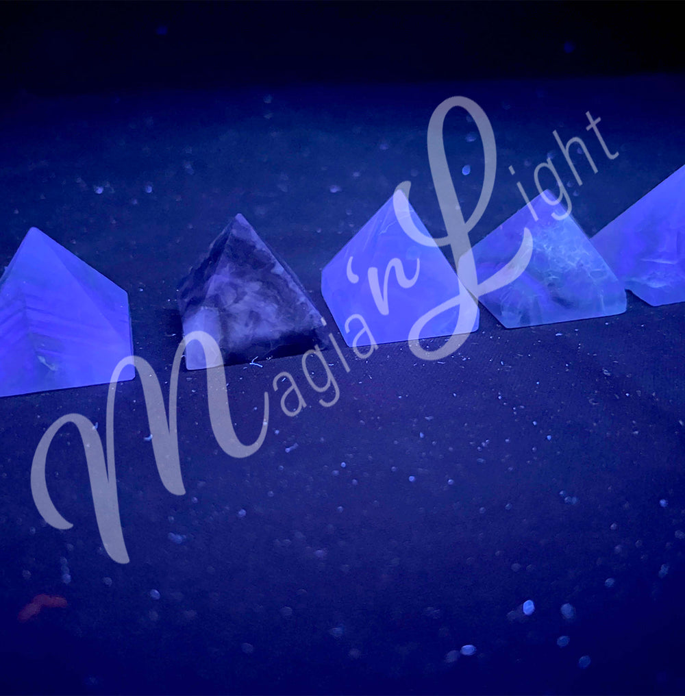 Five pyramid made of Fluorite, seen under UV light.