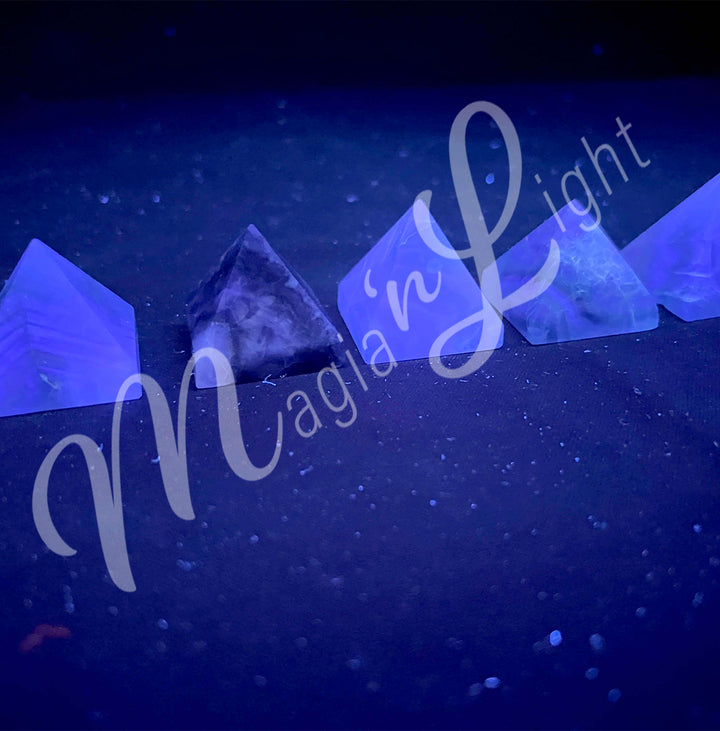 Five pyramid made of Fluorite, seen under UV light.