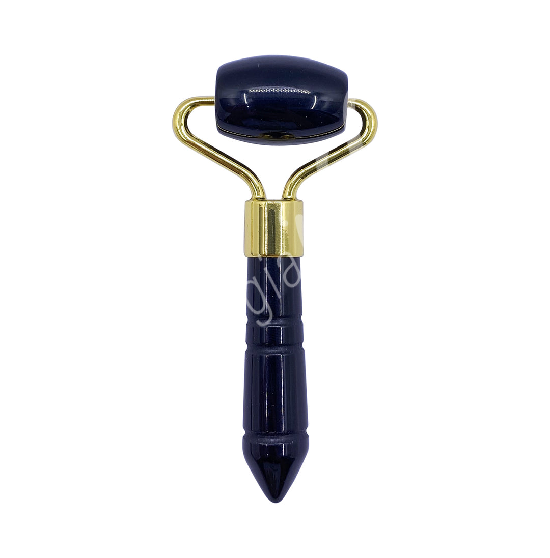 Black obsidian facial roller with a gold frame and a pointed handle for targeted facial massage.