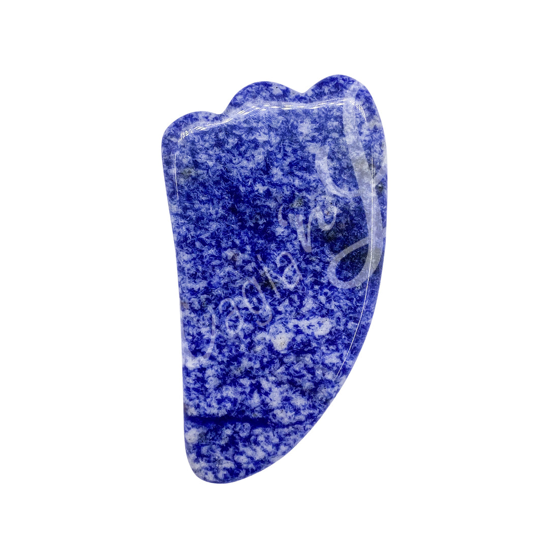 Sodalite gua sha massage stone with a smooth curved shape and scalloped edge.