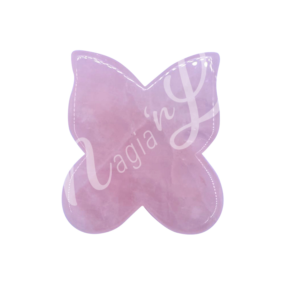 Butterfly-shaped gua sha stone in rose quartz, designed for facial massage and lymphatic drainage.