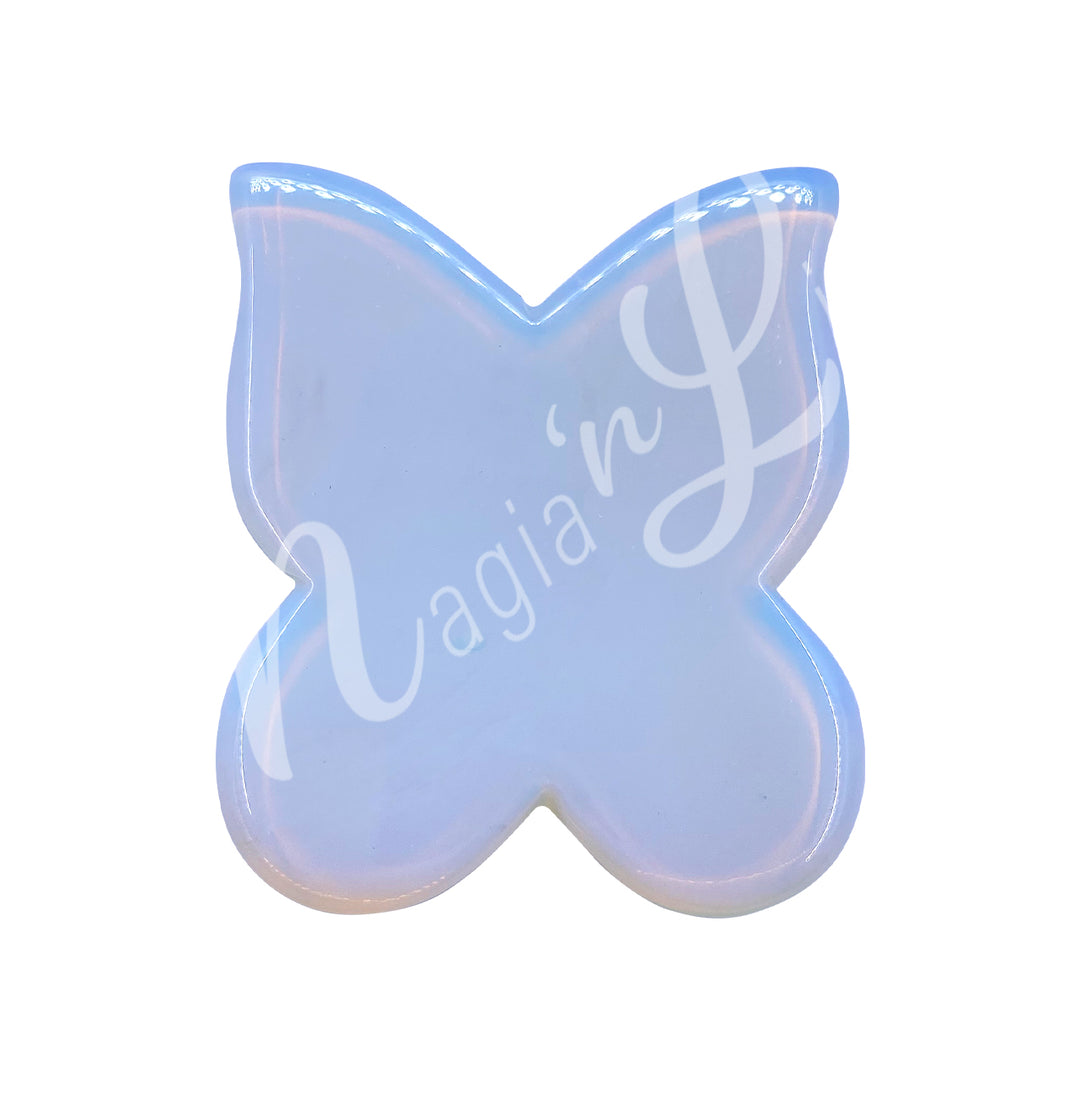 Butterfly-shaped gua sha stone in opalite, designed for facial massage and lymphatic drainage.