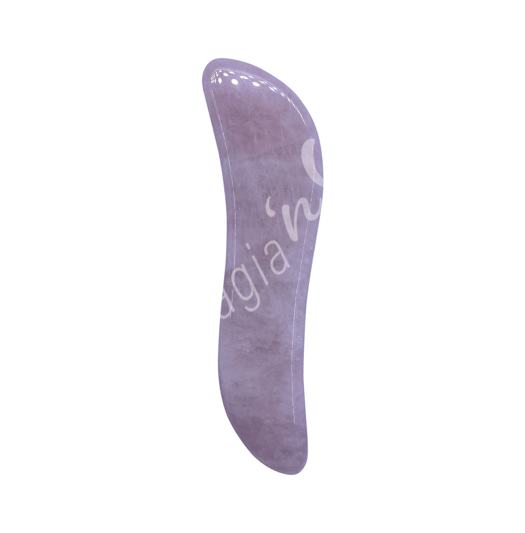 Rose quartz gua sha massage stone with a slim, curved shape and smooth polished surface.