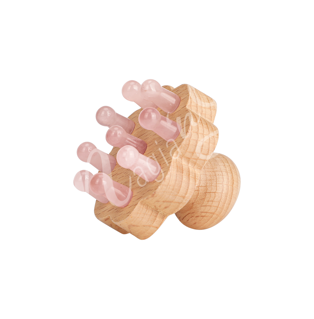 Wooden handheld massager with multiple rounded rose quartz knobs used for muscle relaxation and stimulation.