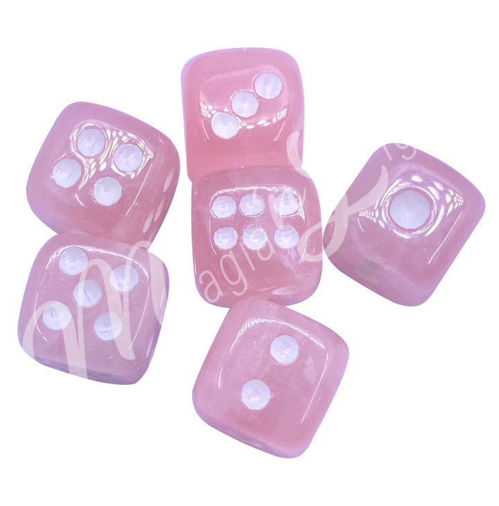 Set of six polished rose quartz gemstone dice with white engraved dots.