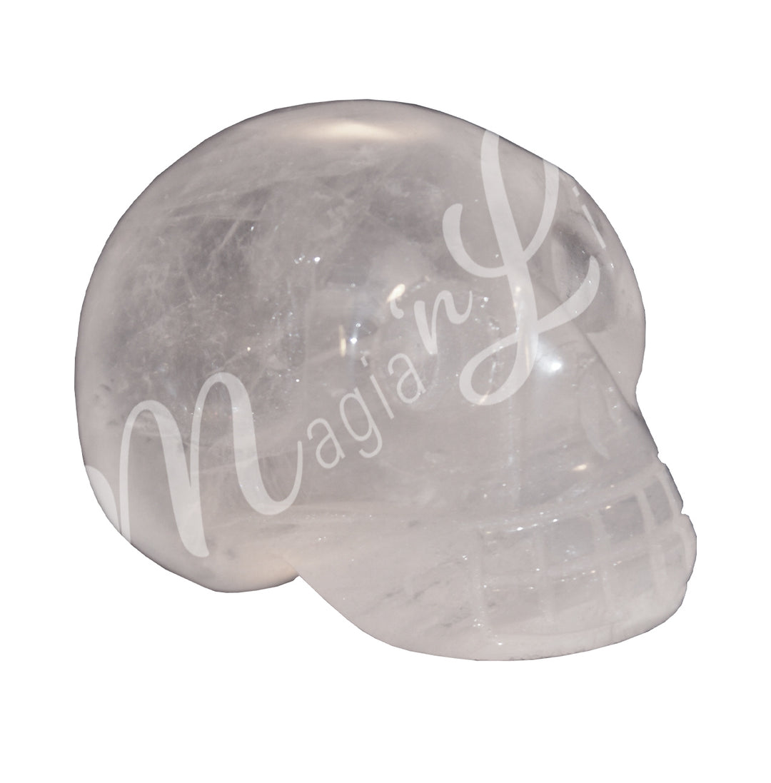 A polished skull carving made of crystal quartz.