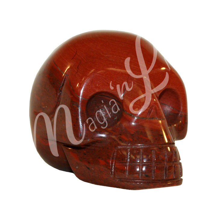 A polished skull carving made of red jasper. Seen with an other angle.