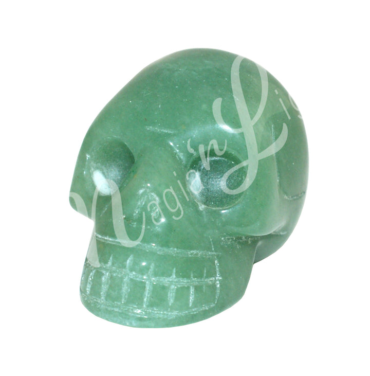A polished skull carving made of green aventurine.