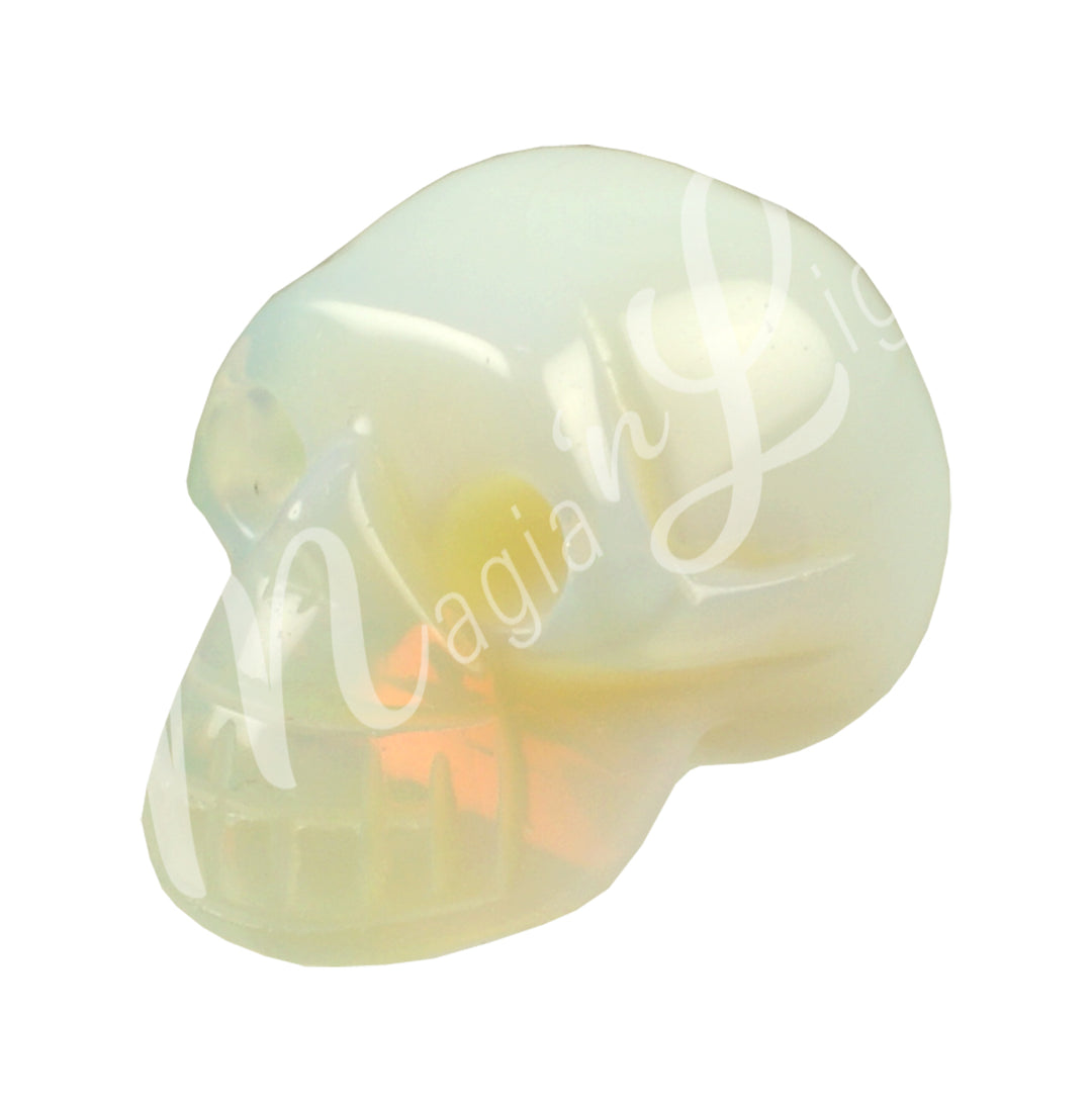 A polished skull carving made of opalite.