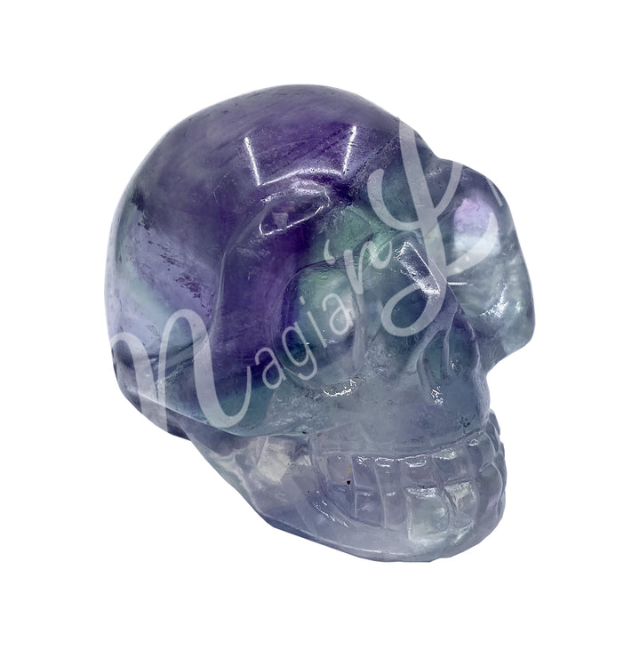 A polished skull carving made of fluorite.
