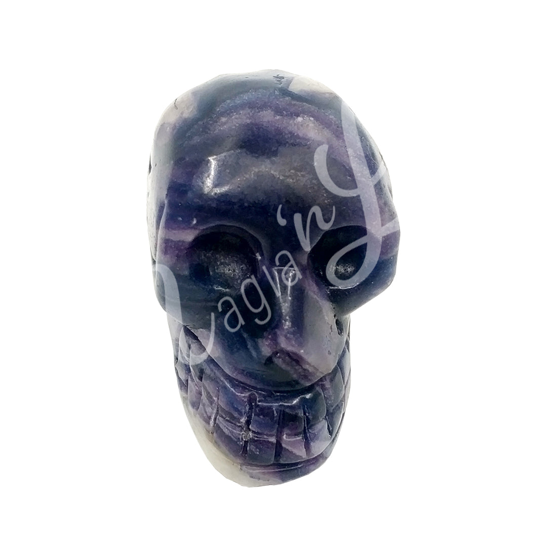 A polished skull carving made of fluorite-color jasper.