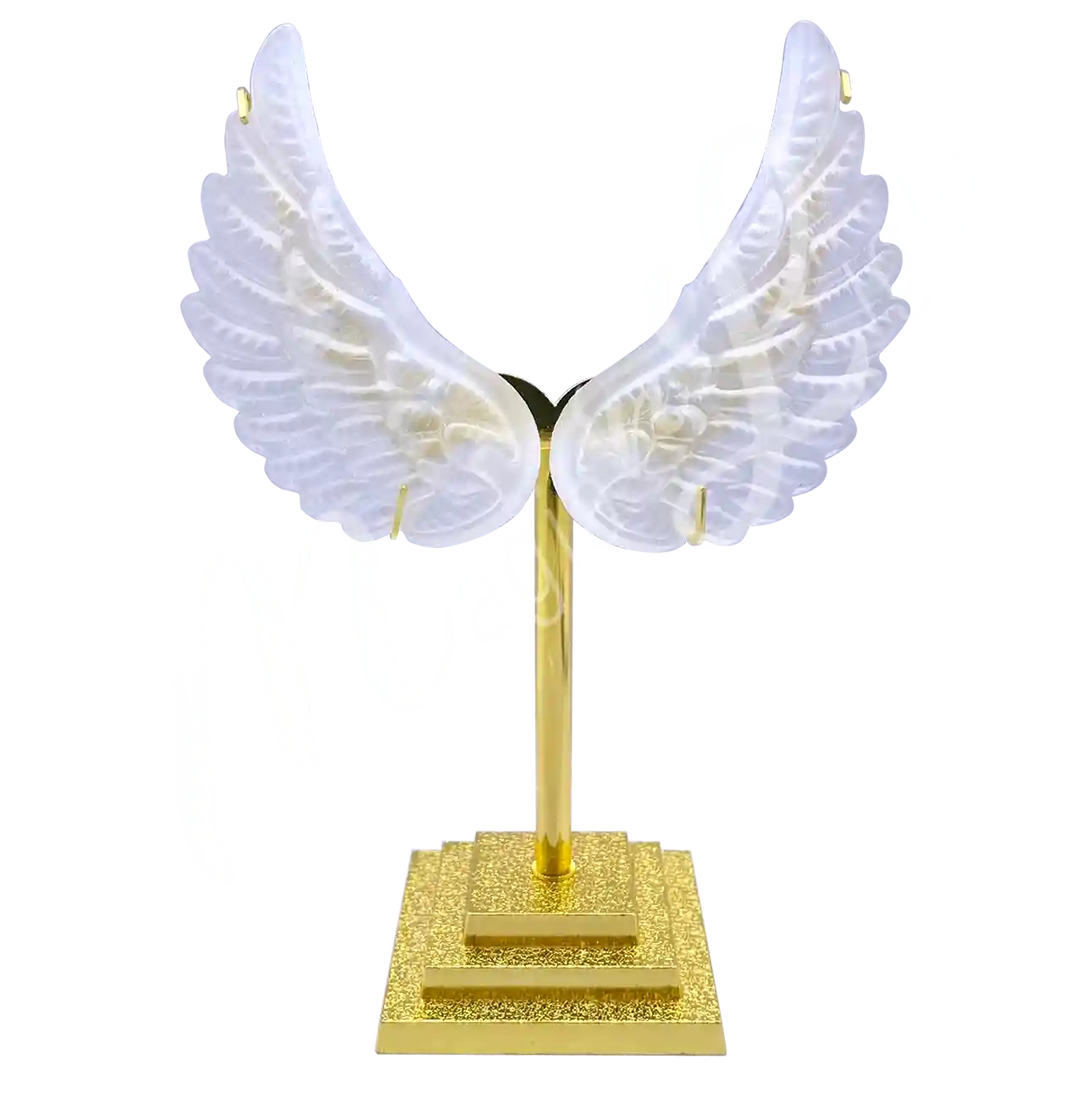 Pair of carved crystal quartz angel wings displayed upright on gold color metal stands.
